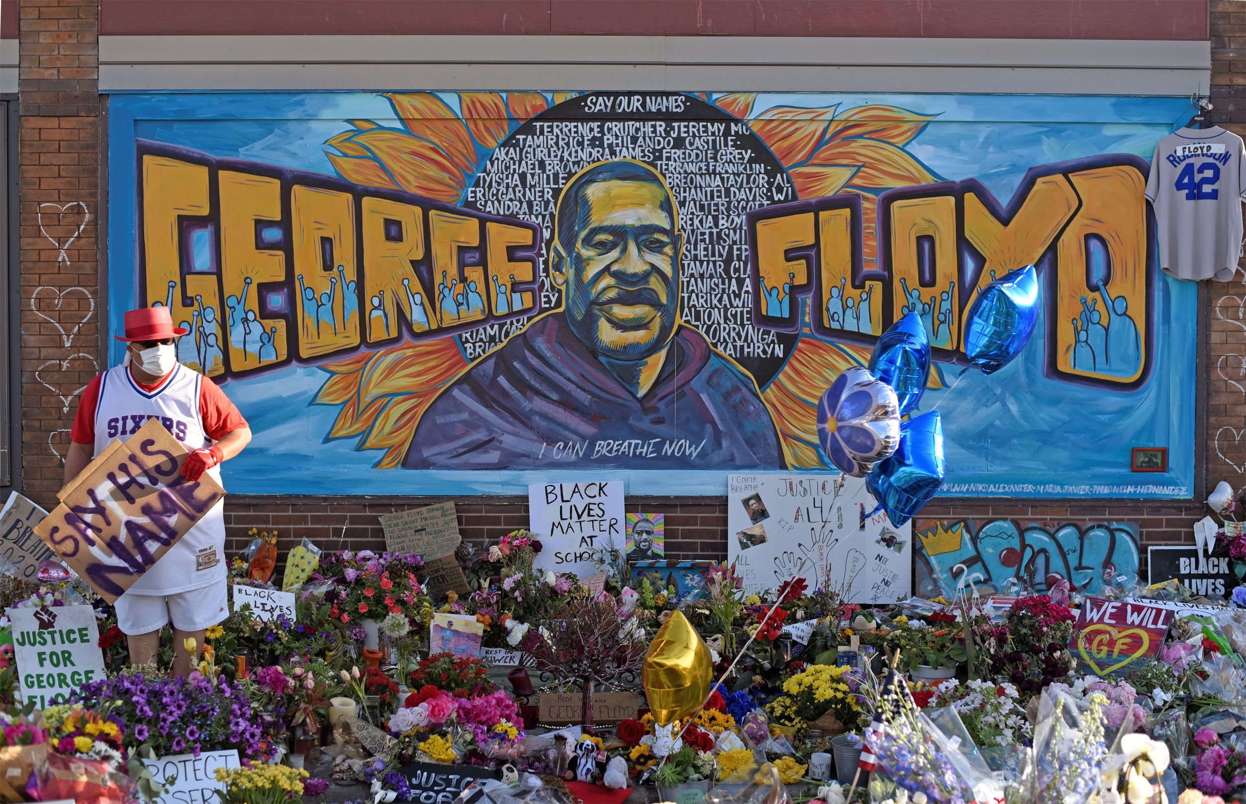 Image: Community members visit the site of George Floyd's killing